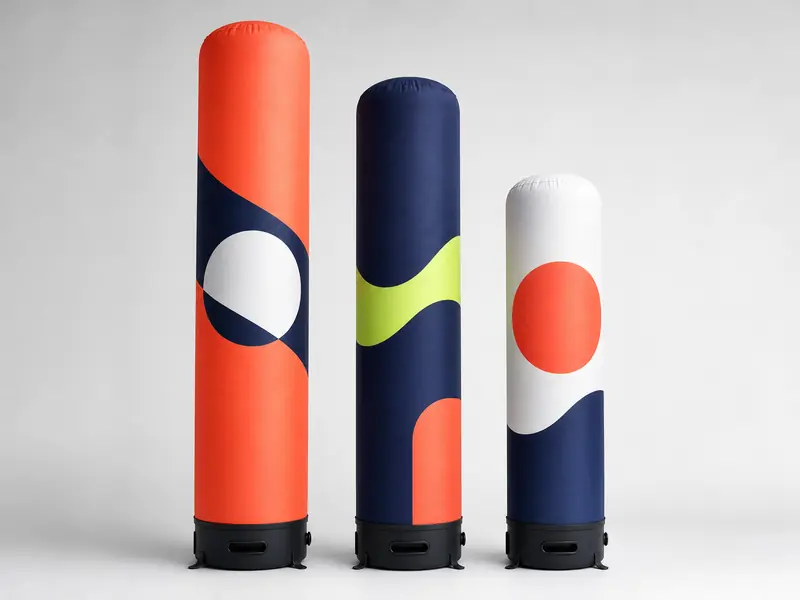 Three inflatable columns of different heights in a studio